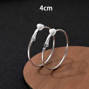 Close-up detail van zilveren oorringen, 4cm grote cirkel metalen clip oorbellen voor vrouwen