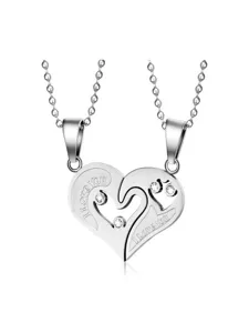 Close-up detail of interlocking heart couple rhinestone pendant necklace set with delicate chain.