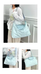 Light blue large capacity nylon travel tote bag with shoulder strap and stars embroidery for women.