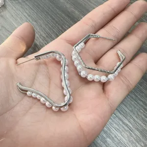 Stijlvolle geometrische oorbellen met parels en een uniek asymmetrisch ontwerp voor dames.