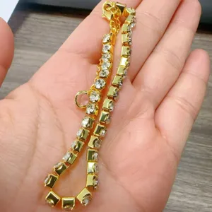 Detailed view of the gold-plated rhinestone tennis bracelet, showcasing sparkling crystal stones.