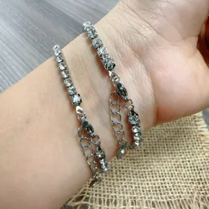 Detail shot of sparkling rhinestone tennis bracelet, showcasing shiny zircon and chain link.