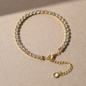 Gold tennis bracelet featuring sparkling cubic zirconia stones, elegant design with extension chain.