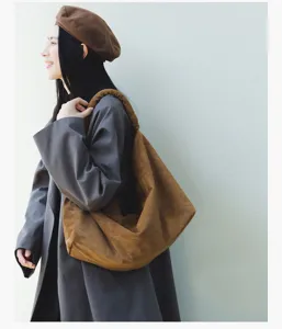 Detail view of a retro brown suede hobo shoulder bag, perfect for daily casual outfits.