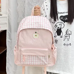 Sac à dos rose à carreaux style mignon pour étudiants avec une jolie broderie de pomme.