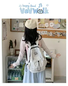 Casual canvas backpack with black and white polka dots, stylish, spacious, and perfect for school daily use.