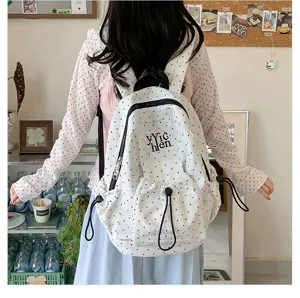 Casual polka dot backpack detail showing large capacity, durable fabric and convenient drawstrings.