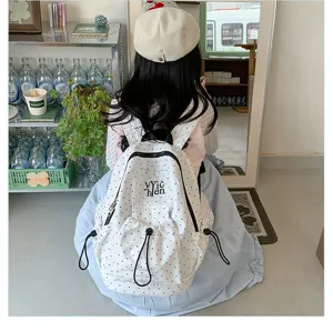 Casual white polka dot backpack for daily student use, featuring spacious storage design.