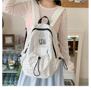 White polka dot backpack for casual student daily use, spacious fashion school bag.