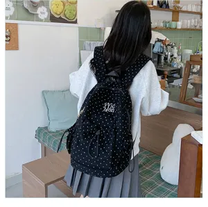 Casual black polka dot backpack detail showing large capacity, cute daily student school bag.