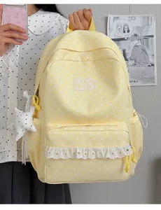 Yellow star pattern backpack detail view, cute lace trim and school bag design for students.