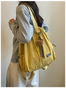 Veelzijdige nylon trekkoord rugzak dames grote capaciteit tote tas met schattige berenhanger.
