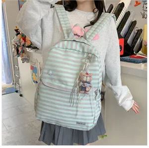 Gedetailleerd overzicht van de gestreepte canvas schoolrugzak in Japanse stijl met berenhanger.