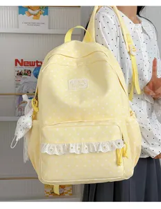 Japanese style cute yellow star print canvas backpack with white lace ruffle for student daily use.
