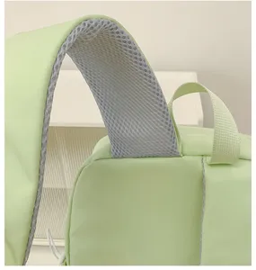 Close-up van de rugzakband met ademend grijs mesh en duurzame lichtgroene stofdetail.