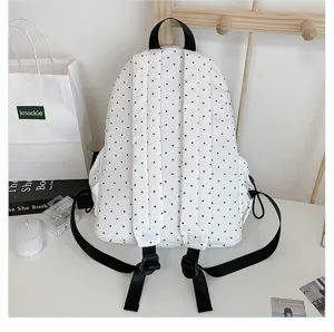 Stylish white backpack with black polka dots, perfect for daily casual use and school students.