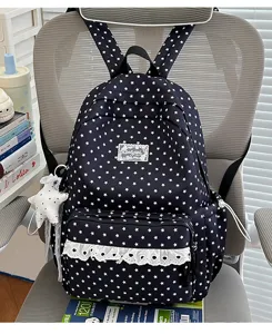 Detailed view of the cute star print backpack with white lace pocket trim and starry pendant.