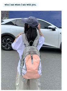Outdoor travel backpack detail showing waterproof fabric, dual straps, and front storage pouch.