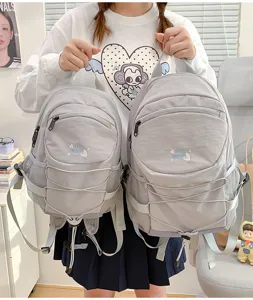 Casual nylon backpack with front elastic cord and large capacity for daily school and travel use.