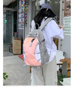 Detail view of lightweight foldable hiking backpack in pink grey, ideal for outdoor travel.