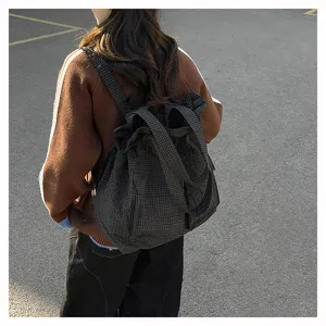 Stylish plaid drawstring backpack, casual canvas travel bag for daily use and outdoor activities.
