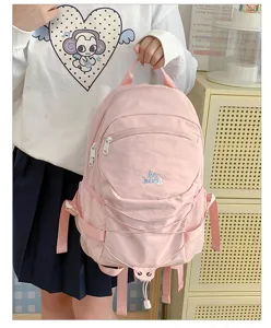 Pink canvas backpack with drawstring and front pockets, ideal for casual campus daily use.