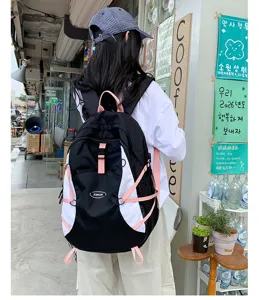 Durable black white backpack with pink straps, ideal for outdoor travel, school and daily use.