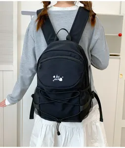 Casual black canvas backpack with drawstring and large capacity for school and daily travel.