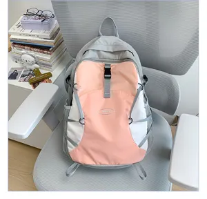 Detailed view of color block casual backpack with bungee cords and front buckle on chair.
