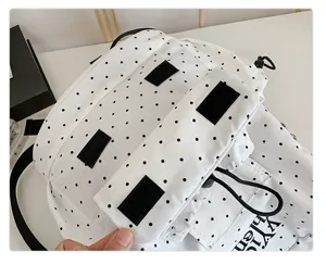 Stylish white canvas backpack with black polka dots, casual student school bag with velcro.