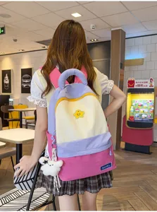 Korean style color-block student backpack with cute star patch and plush bear pendant.