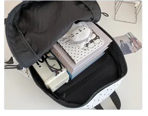 Stylish black and white polka dot backpack with large capacity, ideal for students and daily casual wear.