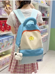 Korean style cute colorblock backpack detailed look with star patch and fluffy dog charm.
