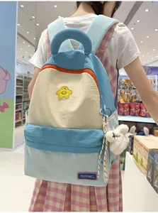 Korean style cute colorblock student backpack with fluffy bear pendant and star embroidery.