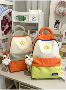 Korean style colorblock student backpack, cute school bag with star patch and plush bunny pendant.