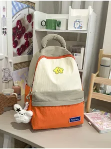 Cute student backpack with contrast color design, large capacity school bag for daily use.