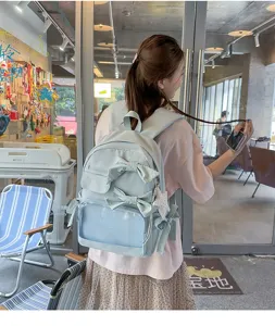 Bonita mochila ita azul claro con lazos y bolsillo transparente, gran bolso escolar elegante.