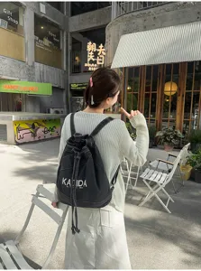 Retro washed denim drawstring backpack for women, casual vintage student commuter large capacity bag.