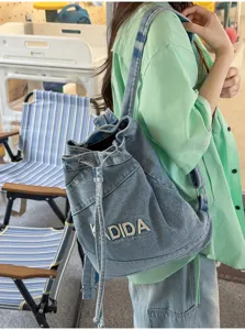 Vintage washed denim bucket backpack for women, large capacity casual student school bag.