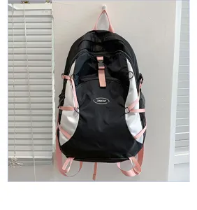 Detail view of the black and white waterproof hiking backpack featuring pink straps.