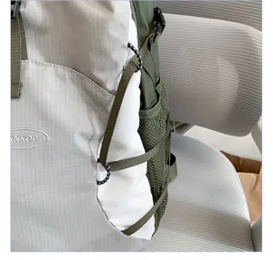 Backpack side detail showing mesh pocket, elastic cords, and durable waterproof fabric.