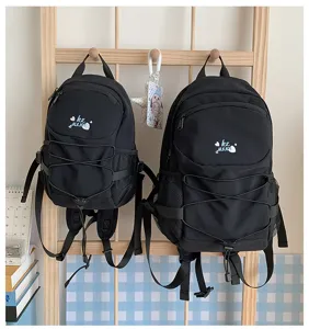 Close-up detail of the stylish black casual backpack with drawstring and mesh side pockets.