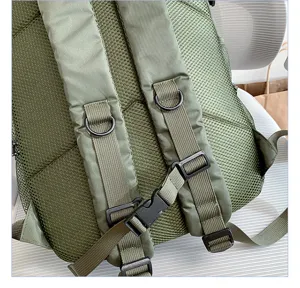 Detailed view of the green tactical backpack back straps, breathable mesh padding, and secure buckles.