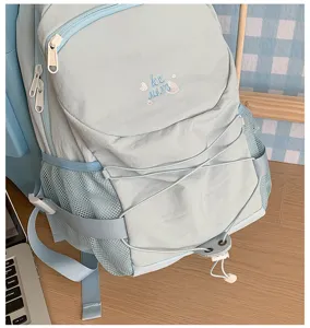Light blue casual backpack with drawstring and mesh side pockets, ins style campus bookbag.