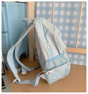 Lightweight casual blue backpack, side view showing mesh pocket, zipper and straps.
