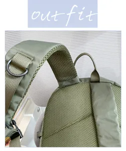 Close-up detail of green waterproof hiking backpack breathable mesh shoulder strap.