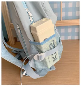 Light blue casual backpack detail showcasing side mesh pocket and adjustable strap design.