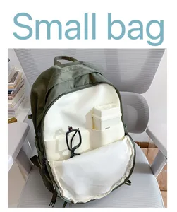 Detailed view of the army green backpack featuring multiple interior storage compartments.