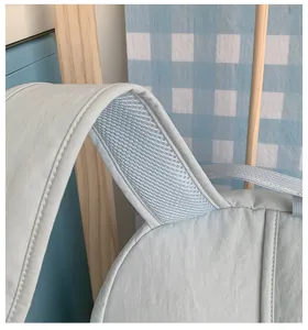 Close-up detail of light blue backpack shoulder strap with breathable mesh fabric