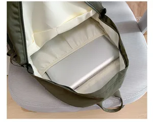 Backpack interior detail showing large capacity laptop compartment and neat lining storage.